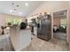 Well-lit kitchen with stainless steel appliances, white cabinets, and an open layout at 9432 Se 159Th Ln, Summerfield, FL 34491