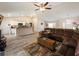 Open-concept living room and kitchen area with light wood flooring and neutral-colored walls at 9432 Se 159Th Ln, Summerfield, FL 34491