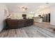 Open-concept living room featuring modern gray floors, and a view of the kitchen at 9432 Se 159Th Ln, Summerfield, FL 34491