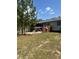 View of backyard, partially cleared, with deck and wooded area at 1013 Nw Mandrake Dr, Dunnellon, FL 34431