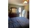 Spacious bedroom featuring a large dresser, ceiling fan and comfortable bed at 1013 Nw Mandrake Dr, Dunnellon, FL 34431