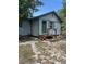 Charming home exterior with green door and trim, complemented by a cozy front porch at 1013 Nw Mandrake Dr, Dunnellon, FL 34431