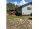 Side view of a home with vinyl siding, small windows, and green trim at 1013 Nw Mandrake Dr, Dunnellon, FL 34431