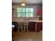 Functional kitchen with ample countertop space and seating beneath a large window at 1013 Nw Mandrake Dr, Dunnellon, FL 34431