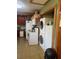 Kitchen with appliances including an oven, refrigerator and stackable washer and dryer at 1013 Nw Mandrake Dr, Dunnellon, FL 34431