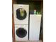 Laundry area with a stackable washer and dryer next to a refrigerator at 1013 Nw Mandrake Dr, Dunnellon, FL 34431