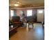 Inviting living room space showcasing comfortable seating and a ceiling fan at 1013 Nw Mandrake Dr, Dunnellon, FL 34431