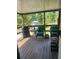 Covered porch area featuring two wicker chairs and a grill at 1013 Nw Mandrake Dr, Dunnellon, FL 34431