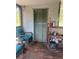 Inviting screened porch with cozy seating and storage at 1013 Nw Mandrake Dr, Dunnellon, FL 34431