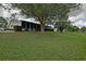 Home with a screened-in patio and a view of the yard and pond at 10699 Se 178Th St, Summerfield, FL 34491