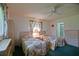 Bedroom features twin beds with floral bedding and a ceiling fan at 10699 Se 178Th St, Summerfield, FL 34491