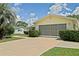 Attached garage with a screened-in door at 10699 Se 178Th St, Summerfield, FL 34491