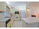 The kitchen features white appliances, cabinetry, and a double basin sink at 10699 Se 178Th St, Summerfield, FL 34491