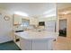 The kitchen features white cabinetry, laminate countertops, and tiled flooring at 10699 Se 178Th St, Summerfield, FL 34491