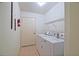 Laundry room featuring tiled floors and white washer and dryer at 10699 Se 178Th St, Summerfield, FL 34491