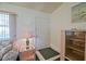 Cozy living room features a white front door, a small table lamp, and a sofa near the window at 10699 Se 178Th St, Summerfield, FL 34491