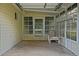 Covered patio with concrete floor, chair, and view of the landscaped yard at 10699 Se 178Th St, Summerfield, FL 34491