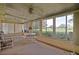 Enclosed sunroom featuring neutral decor, multiple windows, and ceiling fan at 10699 Se 178Th St, Summerfield, FL 34491