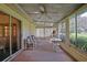 Enclosed sunroom featuring neutral decor, multiple windows, and ceiling fan at 10699 Se 178Th St, Summerfield, FL 34491