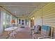 Enclosed sunroom featuring neutral decor, multiple windows, and ceiling fan at 10699 Se 178Th St, Summerfield, FL 34491