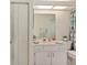 Bathroom featuring a neutral vanity, mirror, and a shower behind a colorful curtain at 11051 Sw 73Rd Ct, Ocala, FL 34476