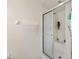All-white bathroom with a shower featuring a glass enclosure and built-in bench at 11051 Sw 73Rd Ct, Ocala, FL 34476