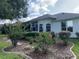 Lush backyard featuring a covered patio, beautiful landscaping, and trees at 11605 Sw 69Th Cir, Ocala, FL 34476