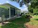 Spacious backyard featuring a covered patio, seating area, and lush landscaping at 11605 Sw 69Th Cir, Ocala, FL 34476