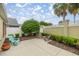 Landscaped backyard with mature trees, seating, and a privacy fence at 1204 Flamingo Pl, The Villages, FL 32162