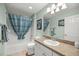 Inviting bathroom features a shower-tub combo with bright vanity lighting at 1204 Flamingo Pl, The Villages, FL 32162