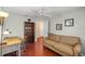 Cozy room features hardwood floors, ceiling fan, and comfortable seating with bookshelves at 1204 Flamingo Pl, The Villages, FL 32162