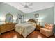 Relaxing bedroom with hardwood floors and ample natural light from the window at 1204 Flamingo Pl, The Villages, FL 32162