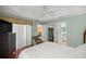 Cozy bedroom featuring a ceiling fan with doorways into a closet and bathroom at 1204 Flamingo Pl, The Villages, FL 32162