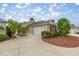 Charming home featuring a two-car garage and meticulously maintained landscaping at 1204 Flamingo Pl, The Villages, FL 32162