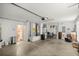 Spacious garage with white walls, a concrete floor, and an exterior door at 1204 Flamingo Pl, The Villages, FL 32162
