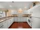 Functional kitchen with clean white cabinetry and updated appliances at 1204 Flamingo Pl, The Villages, FL 32162