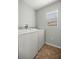 Bright laundry room features a window and a white washer and dryer set at 1204 Flamingo Pl, The Villages, FL 32162