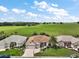 Aerial view of home, features large lawn, mature landscaping, and view of green space at 12169 Se 172Nd Ln, Summerfield, FL 34491