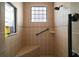 Bathroom shower stall with tile surround, grab bar and bench, enhanced by natural light at 12169 Se 172Nd Ln, Summerfield, FL 34491