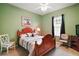 Cozy bedroom with green walls, carpeted floor, and wood furniture at 12169 Se 172Nd Ln, Summerfield, FL 34491