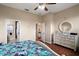 Bedroom with hardwood floors and access to ensuite bathroom and other rooms at 12169 Se 172Nd Ln, Summerfield, FL 34491