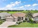Front exterior of home with well maintained lawn, mature palm tree, and large driveway at 12169 Se 172Nd Ln, Summerfield, FL 34491