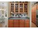 Kitchen features wooden cabinets and granite countertops, with an adjacent dining area illuminated by natural light at 12169 Se 172Nd Ln, Summerfield, FL 34491