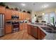 Well-equipped kitchen with stainless steel appliances, granite countertops, and custom wood cabinets at 12169 Se 172Nd Ln, Summerfield, FL 34491