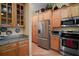 Well-equipped kitchen featuring stainless steel appliances and ample wooden cabinet storage space at 12169 Se 172Nd Ln, Summerfield, FL 34491