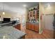 Open kitchen with granite countertops and hardwood floors, seamlessly connected to the dining and living areas at 12169 Se 172Nd Ln, Summerfield, FL 34491