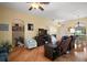 Warm living room with wood floors and a comfortable seating arrangement, perfect for relaxation at 12169 Se 172Nd Ln, Summerfield, FL 34491