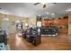 Open-concept living space with hardwood floors, connecting to the kitchen and dining area at 12169 Se 172Nd Ln, Summerfield, FL 34491