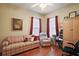 Cozy living room features wood floors, bright natural light, and comfortable furnishings at 12169 Se 172Nd Ln, Summerfield, FL 34491