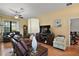 Inviting living room featuring wood floors, comfortable seating, and a modern ceiling fan at 12169 Se 172Nd Ln, Summerfield, FL 34491